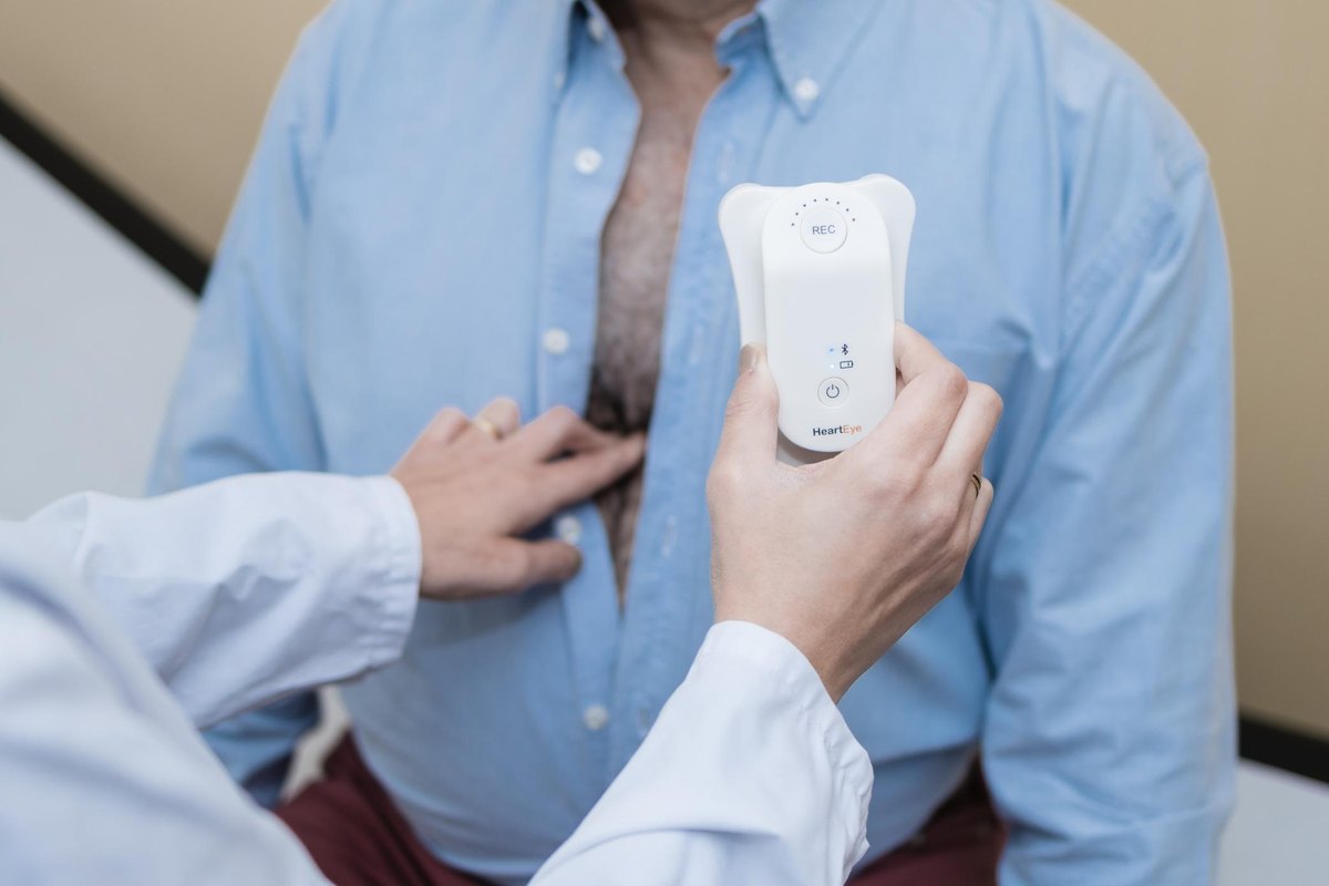 A clinician placing the HeartEye ECG device on a patient&rsquo;s chest.